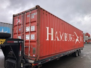 40 foot HC Shipping Container on truck for transport